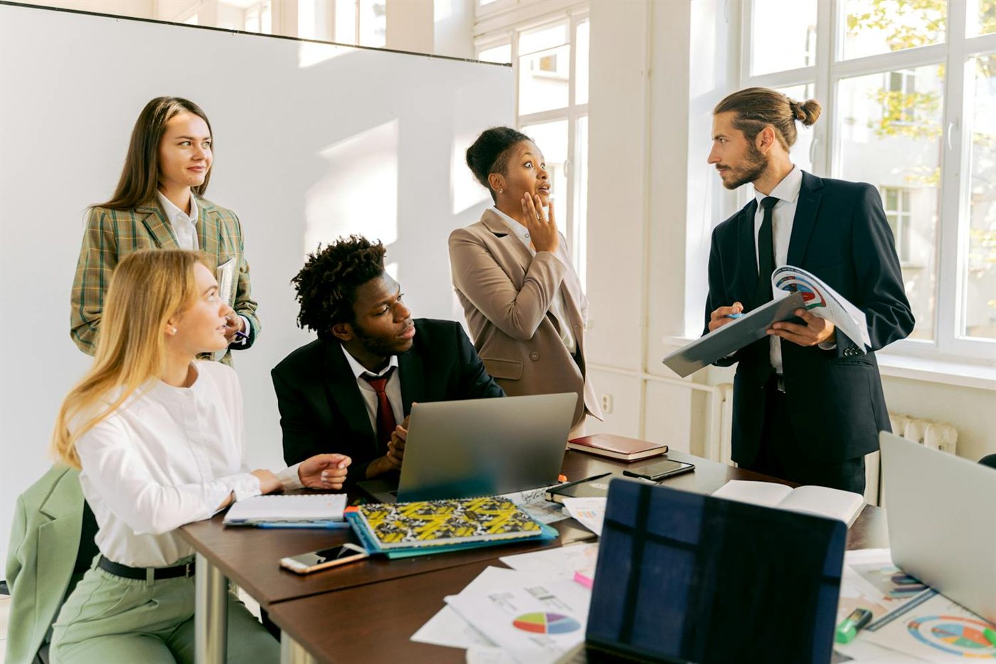 A diverse professional team meeting in a bright office